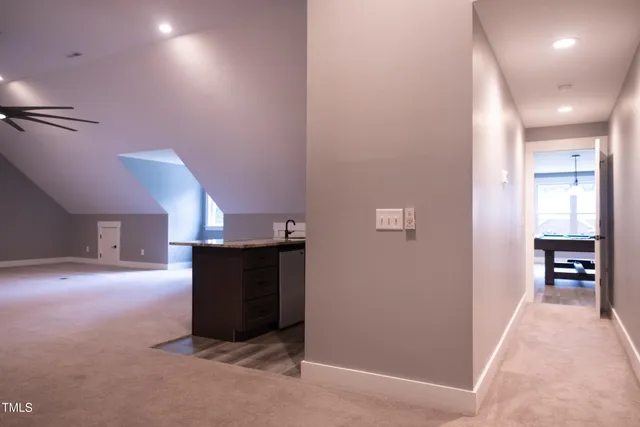 a bathroom with a granite countertop sink a toilet and bathtub