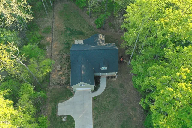 a view of a house with swimming pool and sitting area