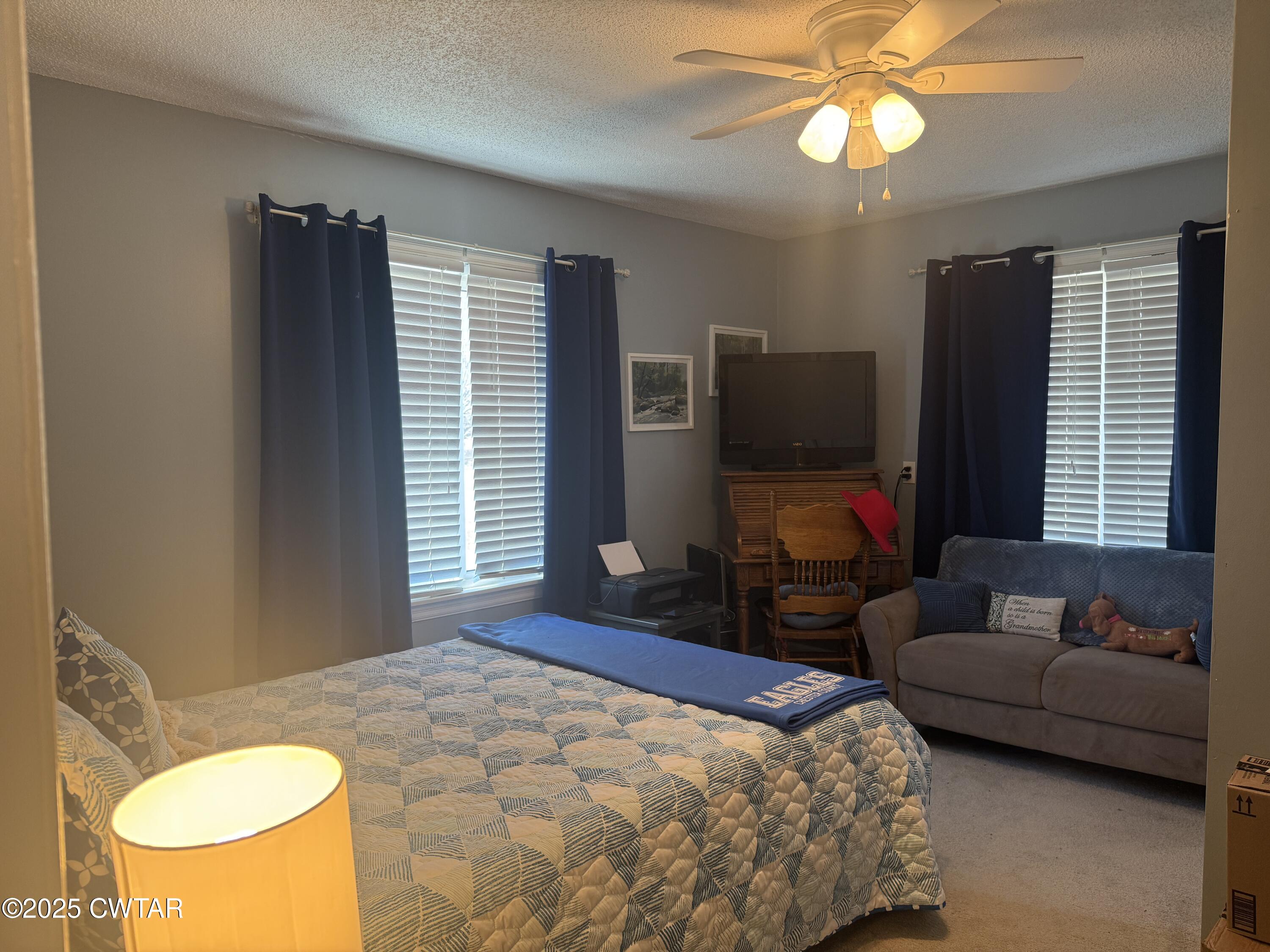 2685 Sunshine Road Henderson, TN 38340 - Photo 33 of 36 a bedroom with a bed and a chandelier