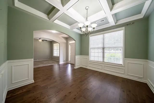 a view of an empty room with a fireplace and a window