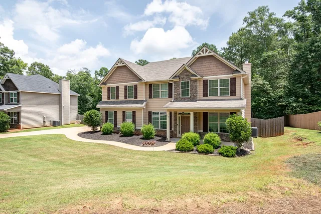 a front view of a house with garden