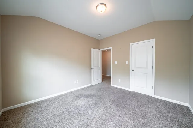 a bathroom with a granite countertop bathtub a sink and a mirror