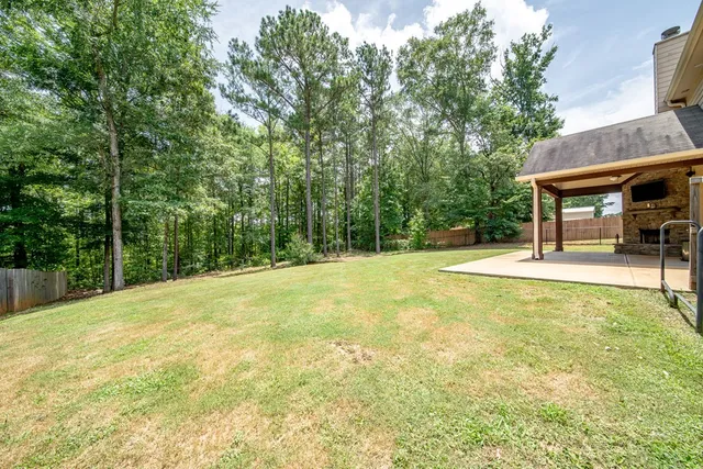 a view of a house with a yard and sitting area