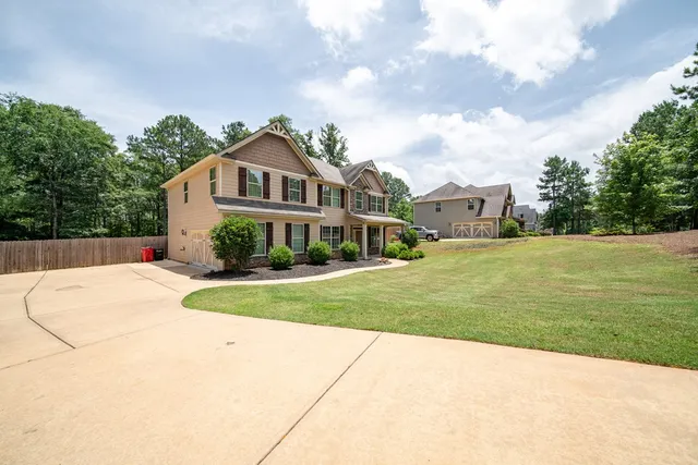 a house with green field in front of it