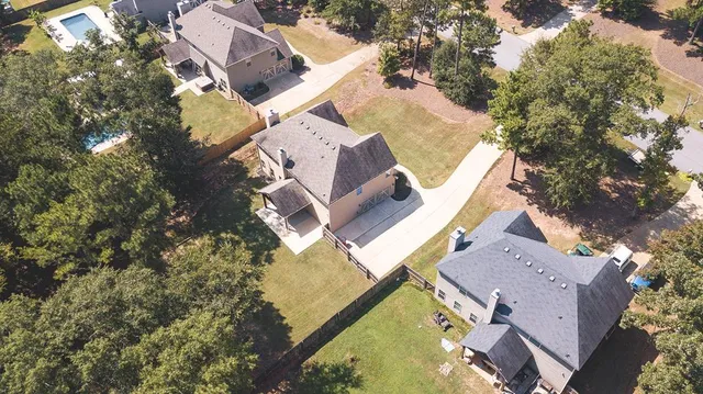 an aerial view of a house with a yard