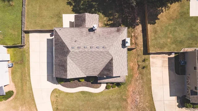 an aerial view of a house with a yard