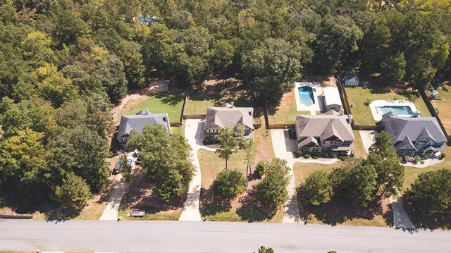 a view of a house with a yard covered with snow in the background