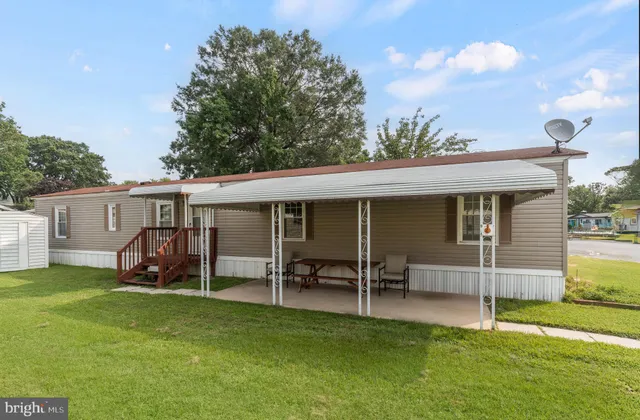 a view of a house with a yard and sitting area
