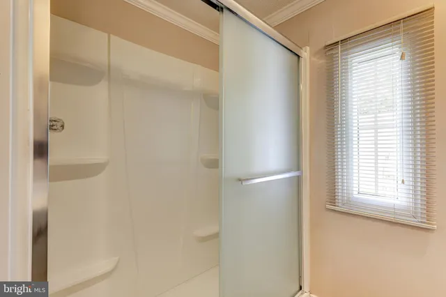 a bathroom with a glass shower door