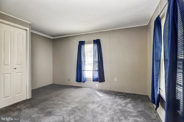 an empty room with windows and closet
