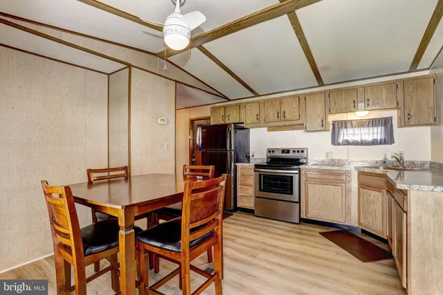 a kitchen with stainless steel appliances a stove a sink dishwasher and a refrigerator