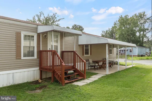 a front view of house with a garden and patio