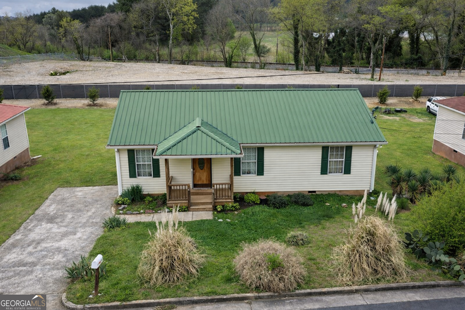 a aerial view of a house with a yard and trees