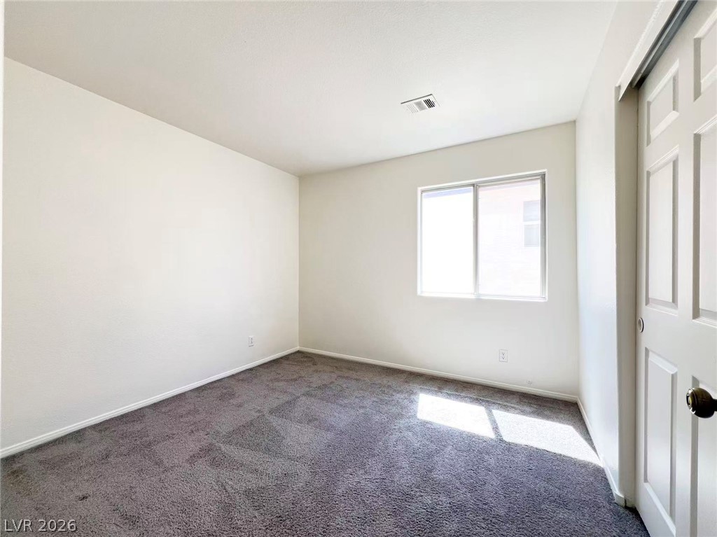 8284 West Rochelle Avenue Las Vegas, NV 89147 - Photo 20 of 29 Well-lit room with plush carpeting and a convenient sliding door entry.