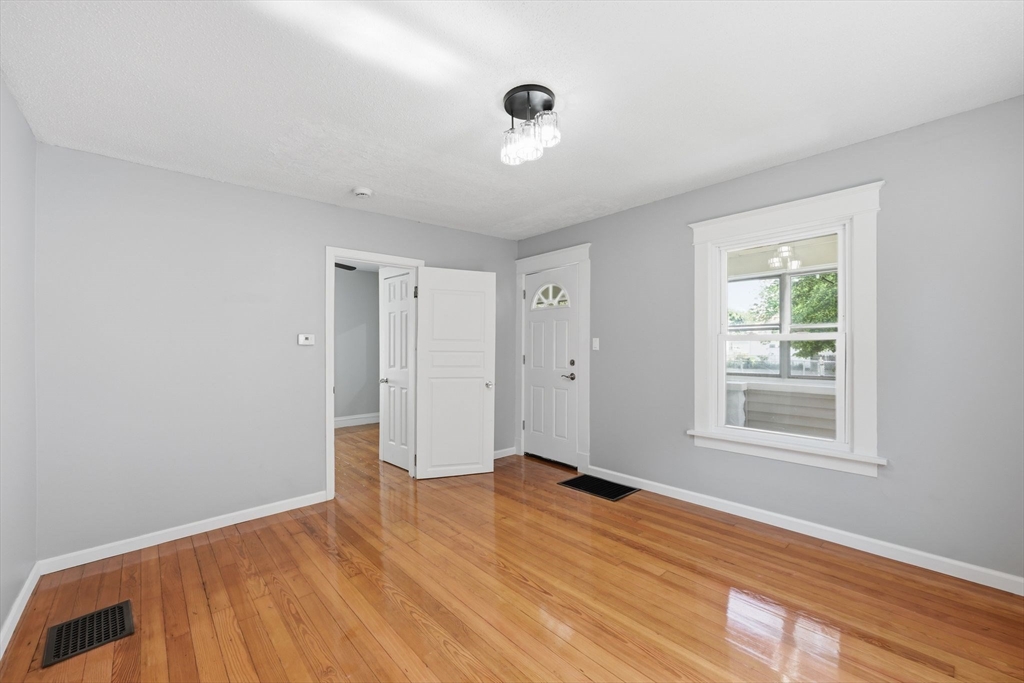 62 Kenyon Street Springfield, MA 01109 - Photo 7 of 26 a view of empty room with wooden floor and fan