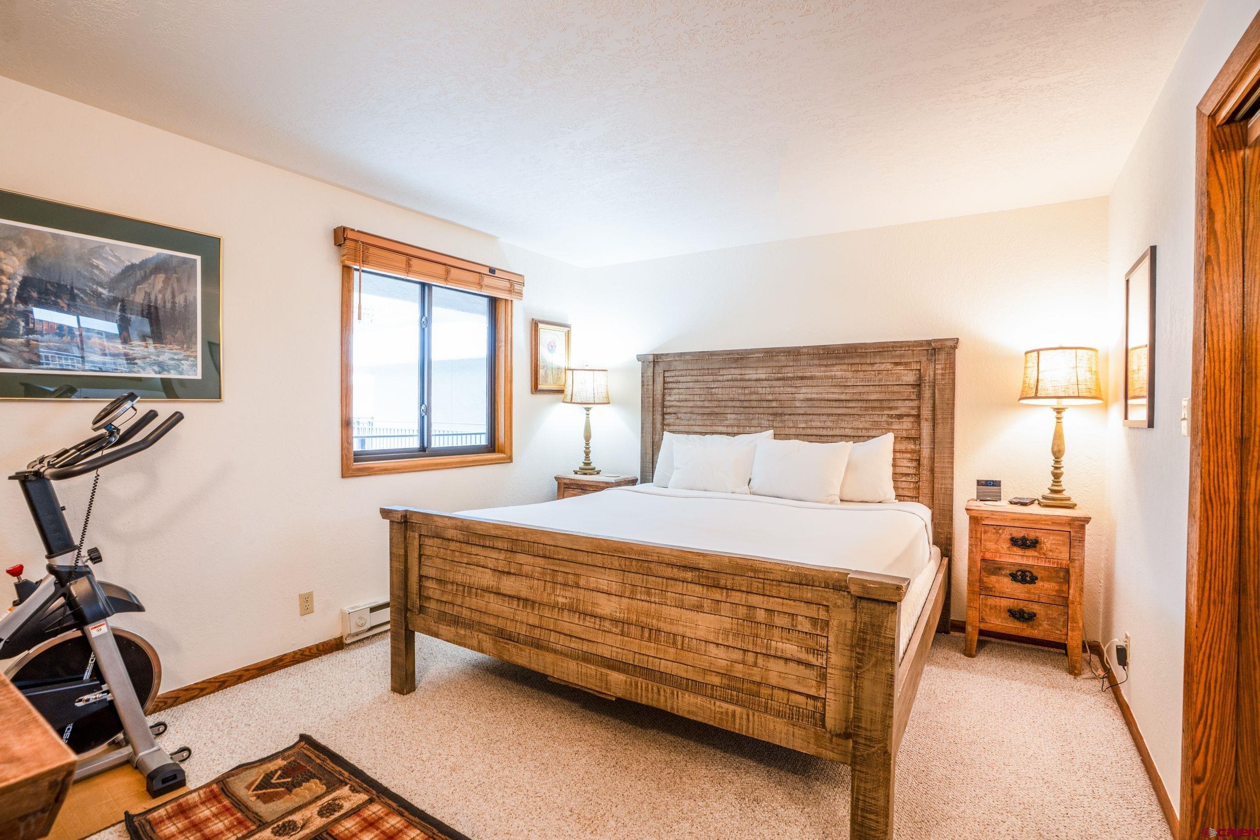 11 Snowmass Road, Unit 440 Crested Butte, CO 81225 - Photo 13 of 41 a bedroom with a bed and a window