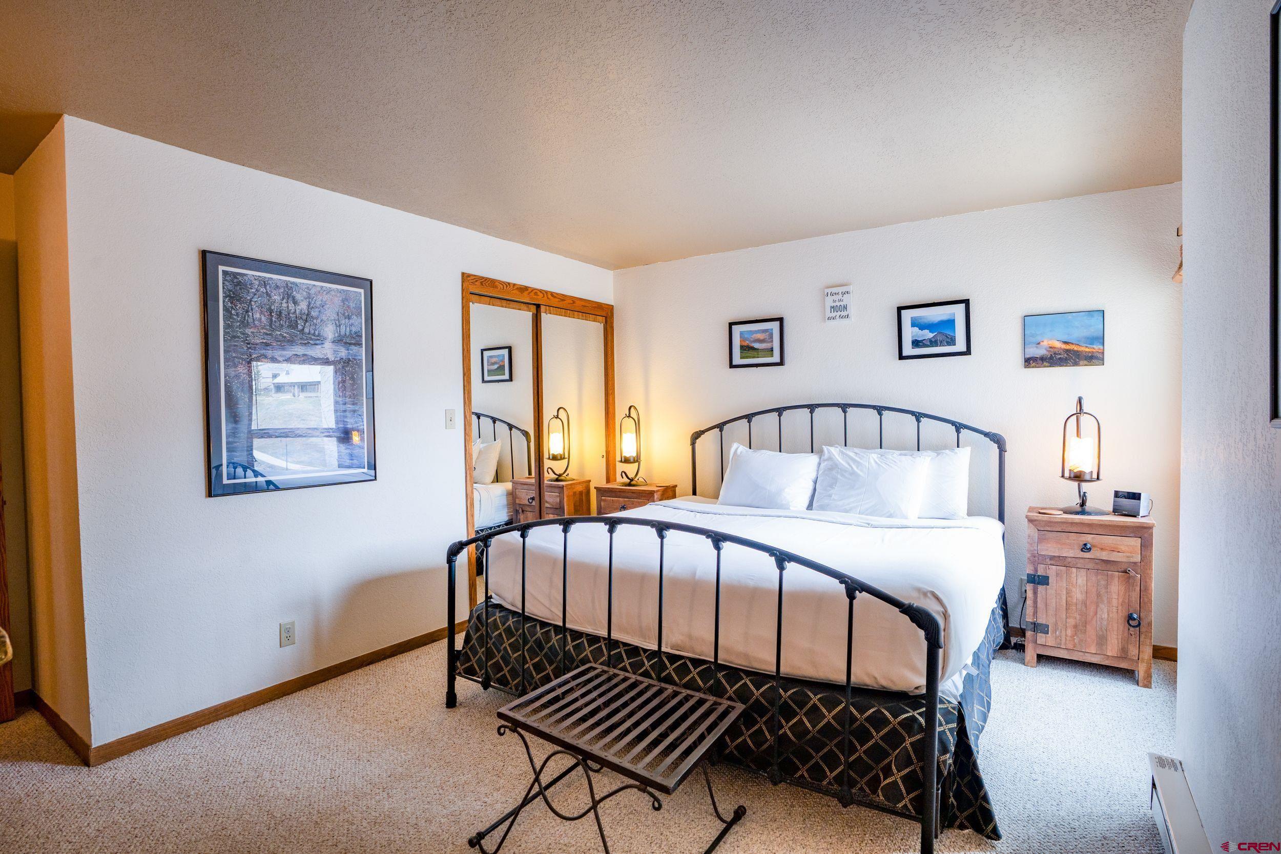 11 Snowmass Road, Unit 440 Crested Butte, CO 81225 - Photo 17 of 41 a bedroom with a bed and a table in it
