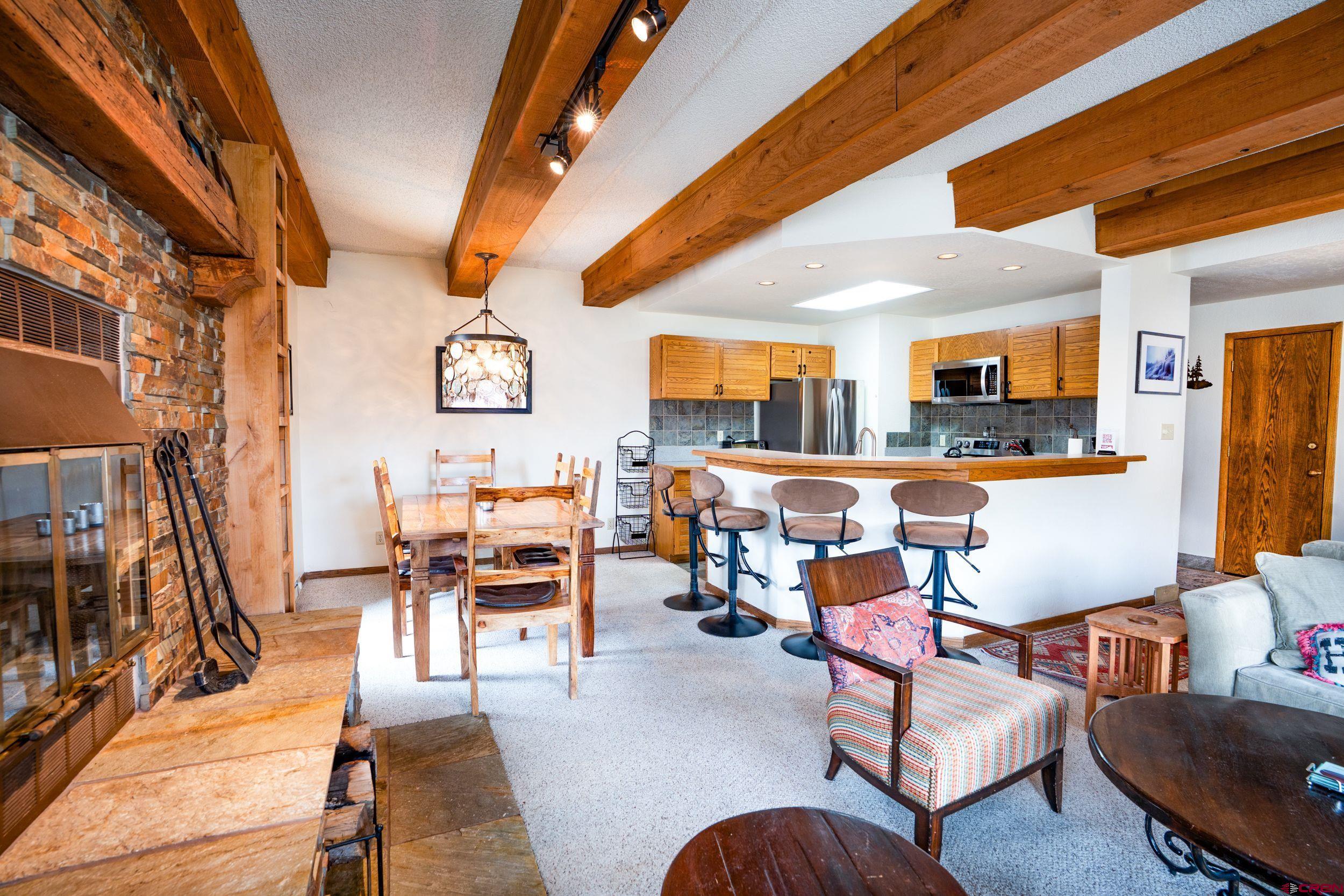 11 Snowmass Road, Unit 440 Crested Butte, CO 81225 - Photo 2 of 41 a living room with furniture and a flat screen tv