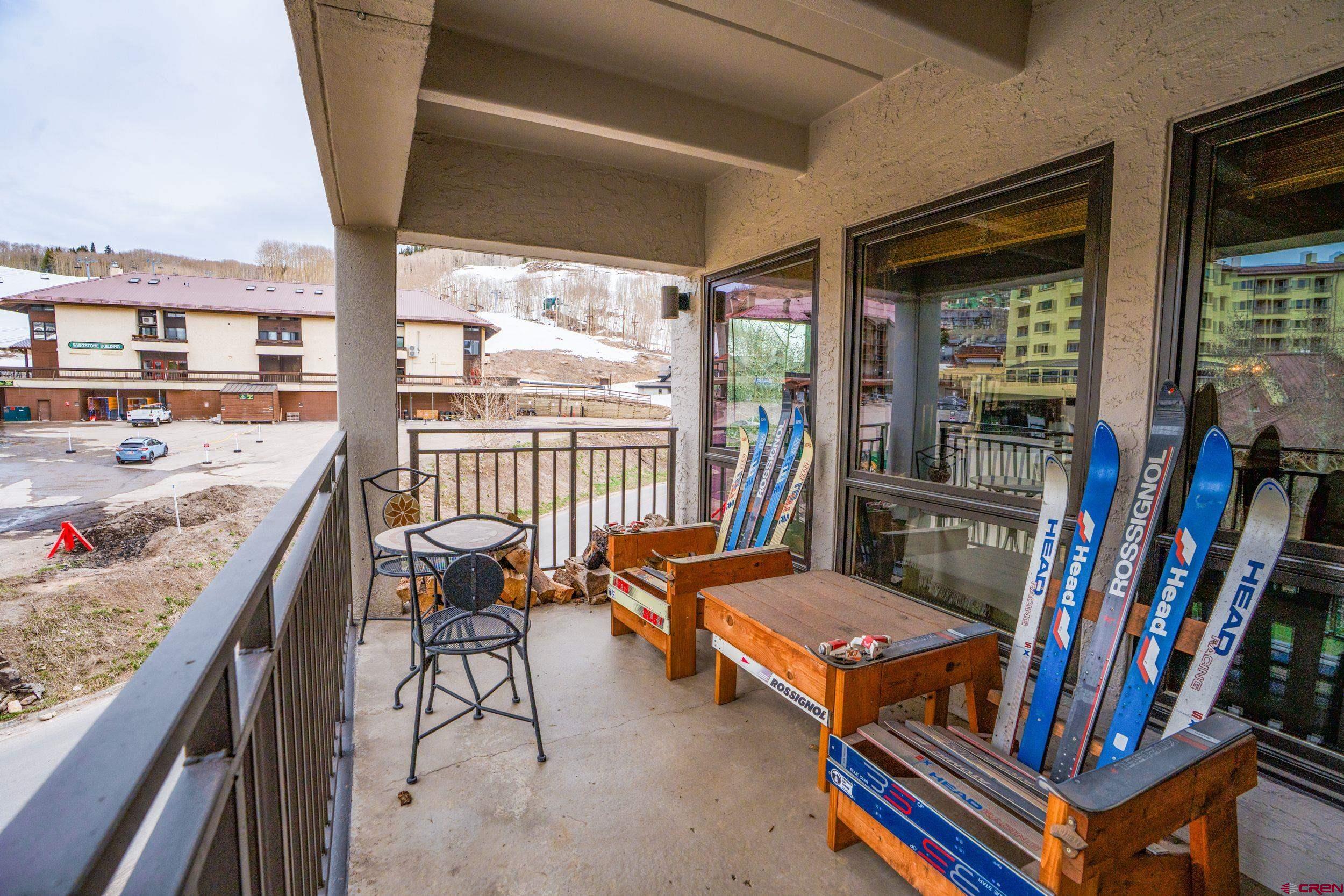11 Snowmass Road, Unit 440 Crested Butte, CO 81225 - Photo 30 of 41 a living room with furniture a rug and a large window