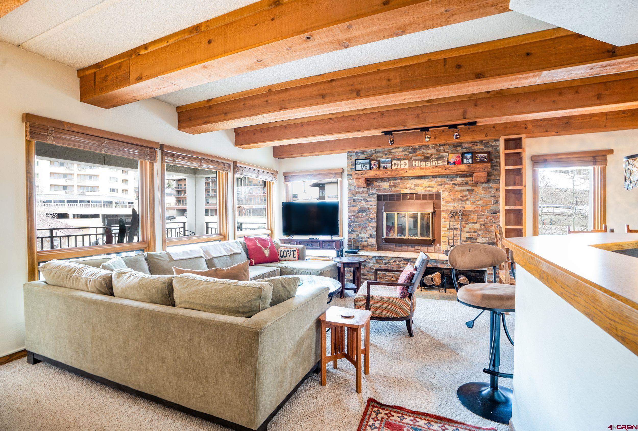11 Snowmass Road, Unit 440 Crested Butte, CO 81225 - Photo 3 of 41 a living room with furniture and a large window