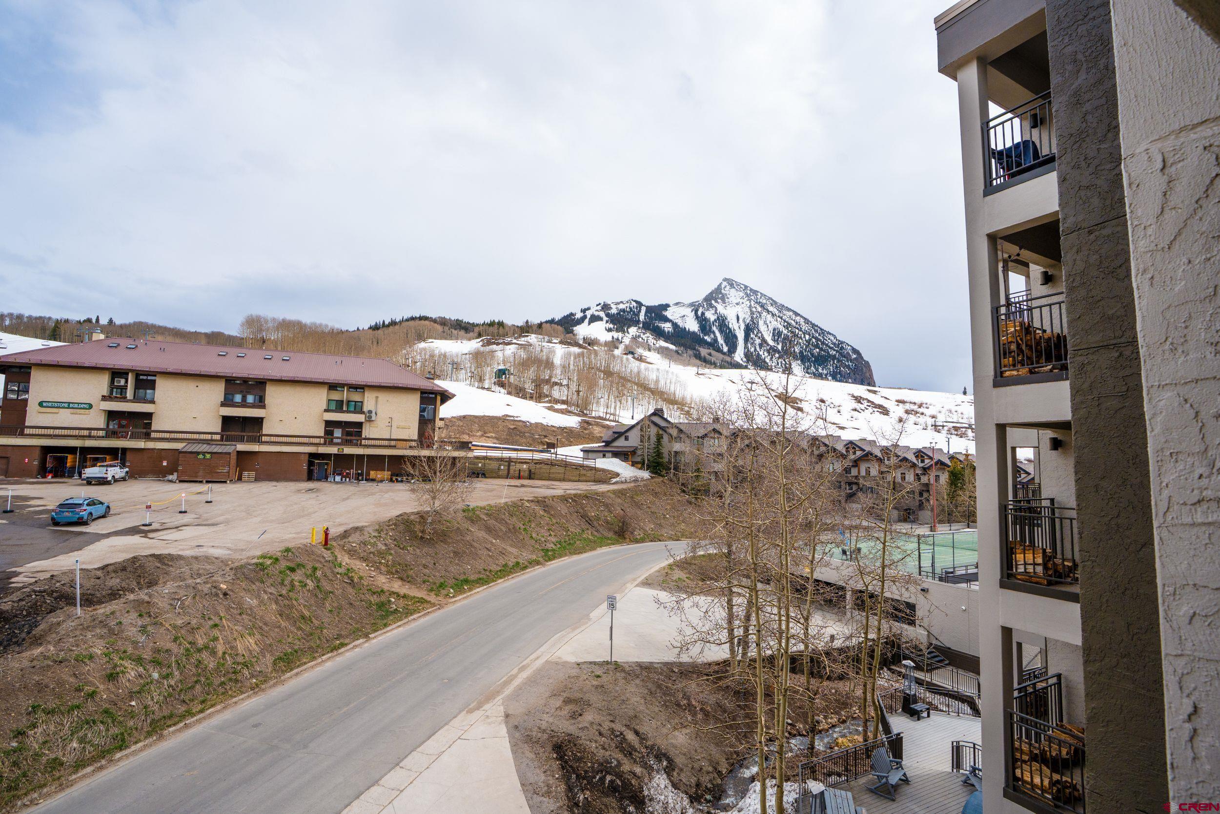 11 Snowmass Road, Unit 440 Crested Butte, CO 81225 - Photo 31 of 41 a view of a terrace with a couch and wooden floor