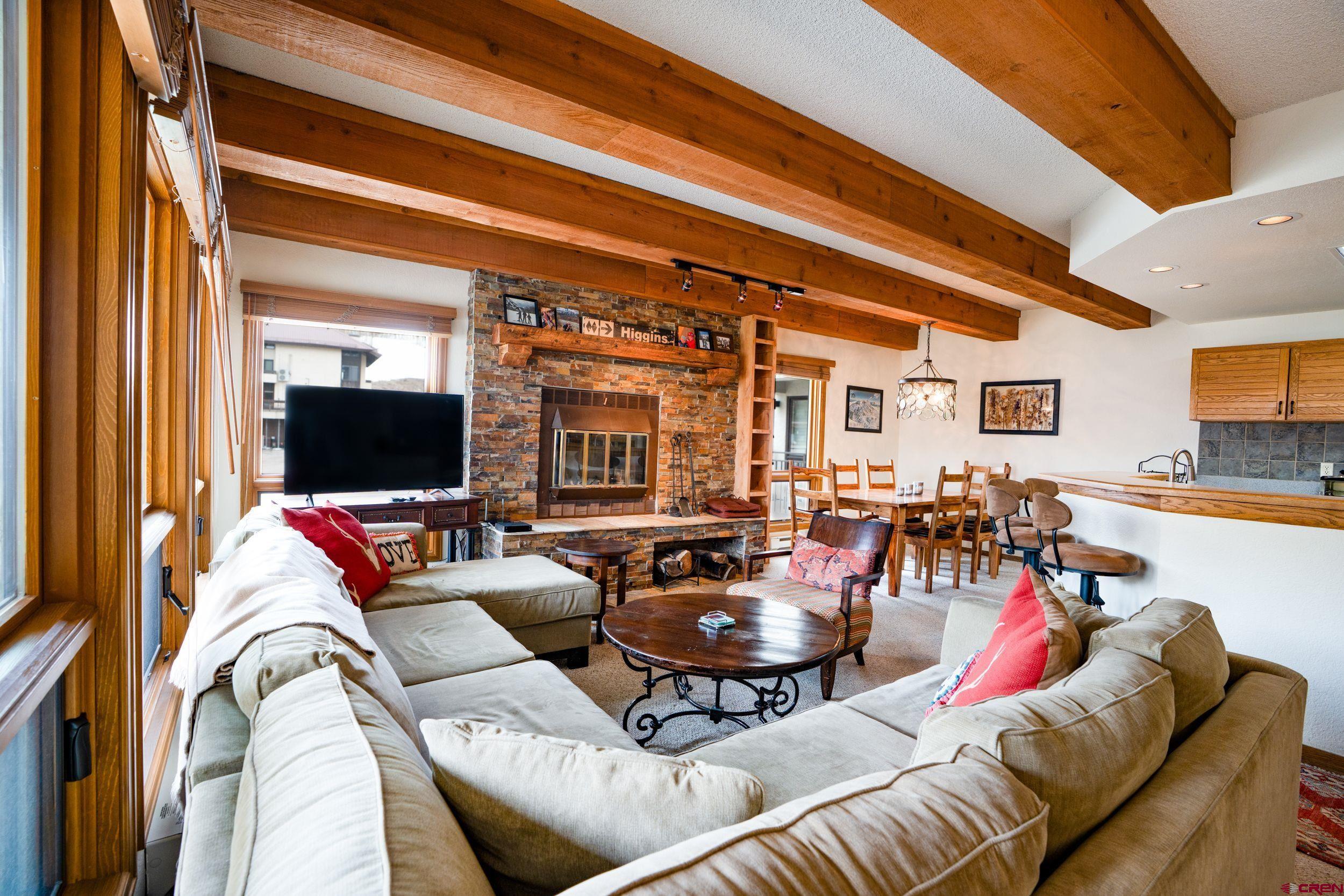 11 Snowmass Road, Unit 440 Crested Butte, CO 81225 - Photo 4 of 41 a living room with furniture and a flat screen tv