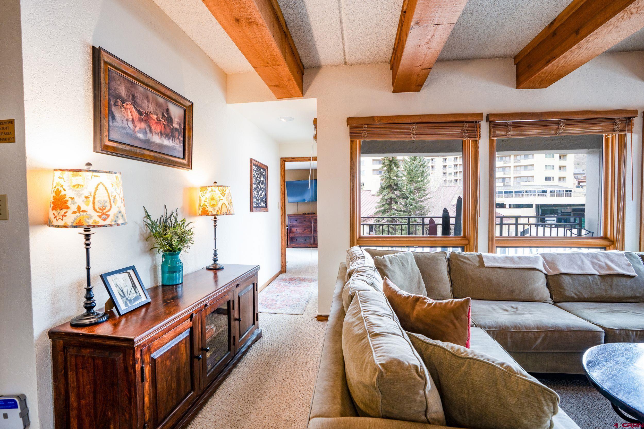 11 Snowmass Road, Unit 440 Crested Butte, CO 81225 - Photo 5 of 41 a living room with furniture and a flat screen tv