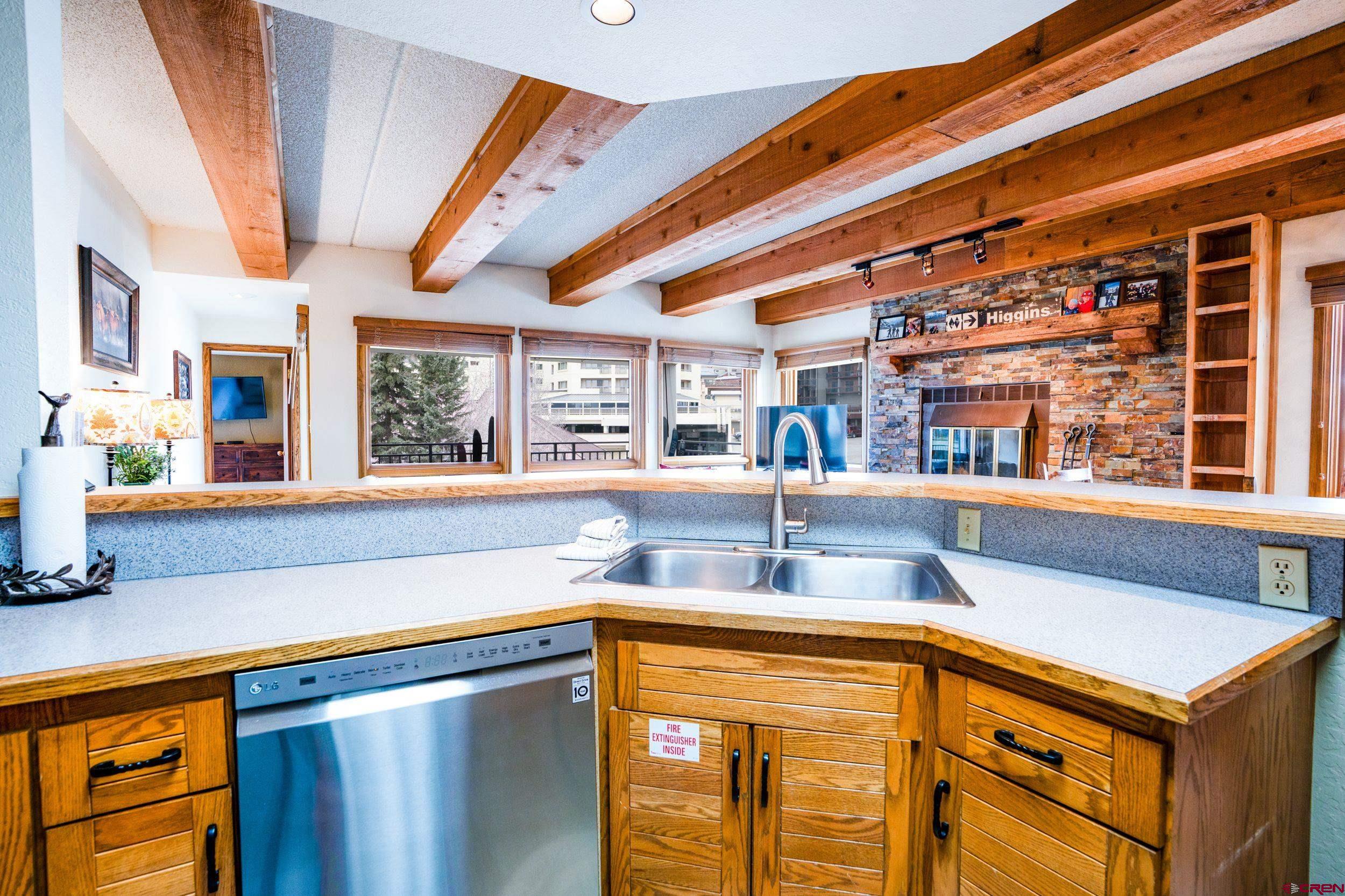 11 Snowmass Road, Unit 440 Crested Butte, CO 81225 - Photo 8 of 41 a kitchen with a refrigerator and a sink