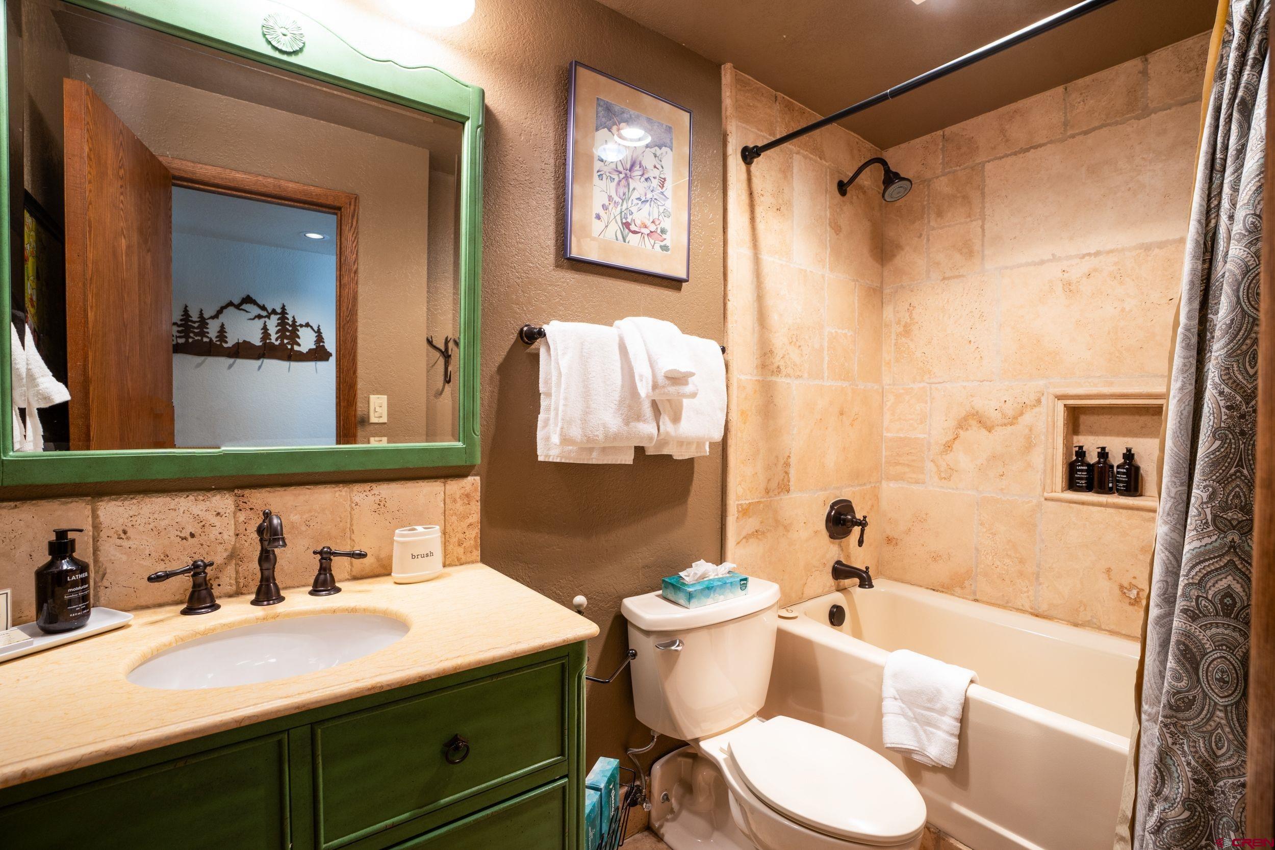11 Snowmass Road, Unit 440 Crested Butte, CO 81225 - Photo 10 of 41 a bathroom with a sink toilet and shower