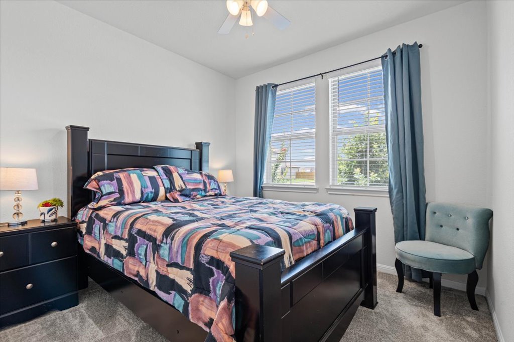 158 Gullivers Drive Elgin, TX 78621 - Photo 23 of 36 Right next door is another generously sized bedroom. It has a big double window facing the front yard, letting in plenty of afternoon light, and easily accommodates a queen-sized bed set with dual nightstands.