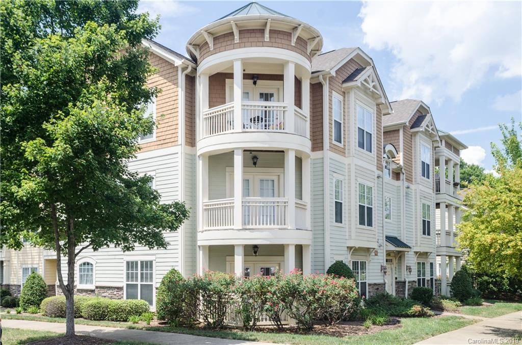 a front view of a residential apartment building with a yard