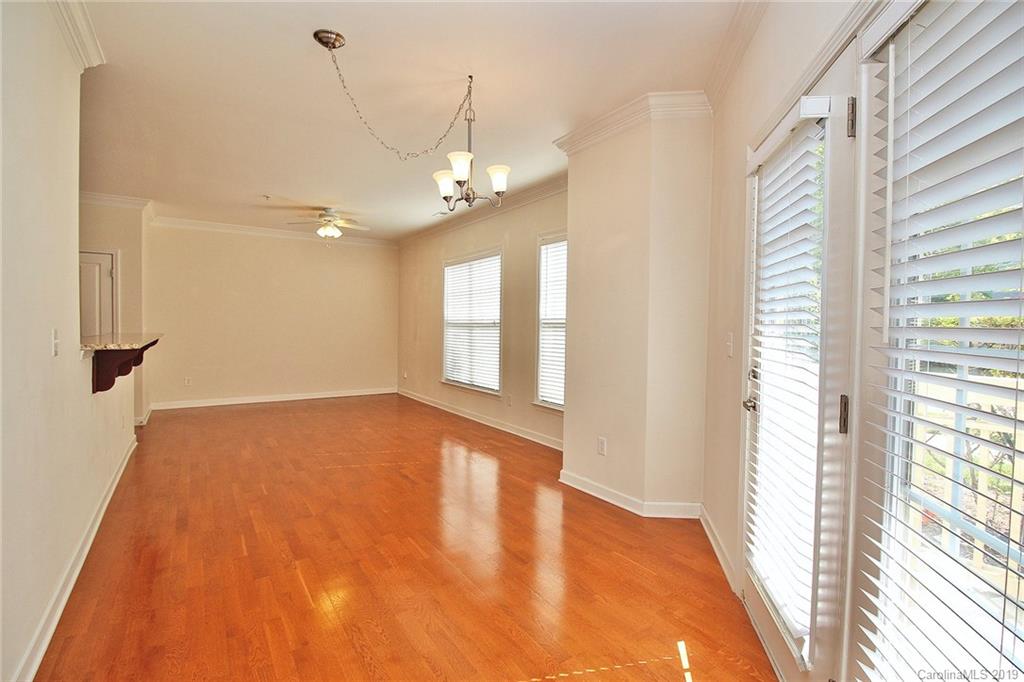 4154 Walker Road Charlotte, NC 28211 - Photo 11 of 37 a view of an empty room with a window and wooden floor