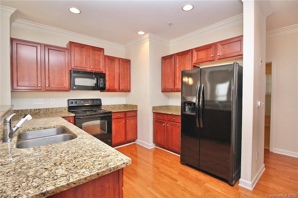 4154 Walker Road Charlotte, NC 28211 - Photo 15 of 37 a kitchen with stainless steel appliances granite countertop a refrigerator a stove top oven and sink