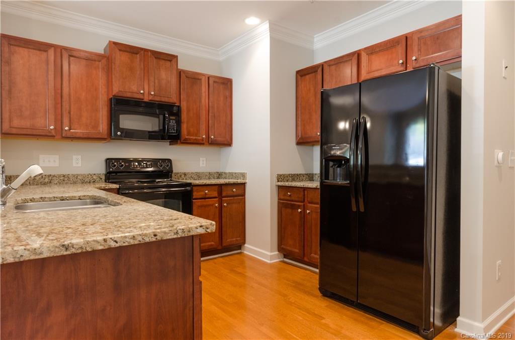 4154 Walker Road Charlotte, NC 28211 - Photo 17 of 37 a kitchen with stainless steel appliances granite countertop a refrigerator and a sink