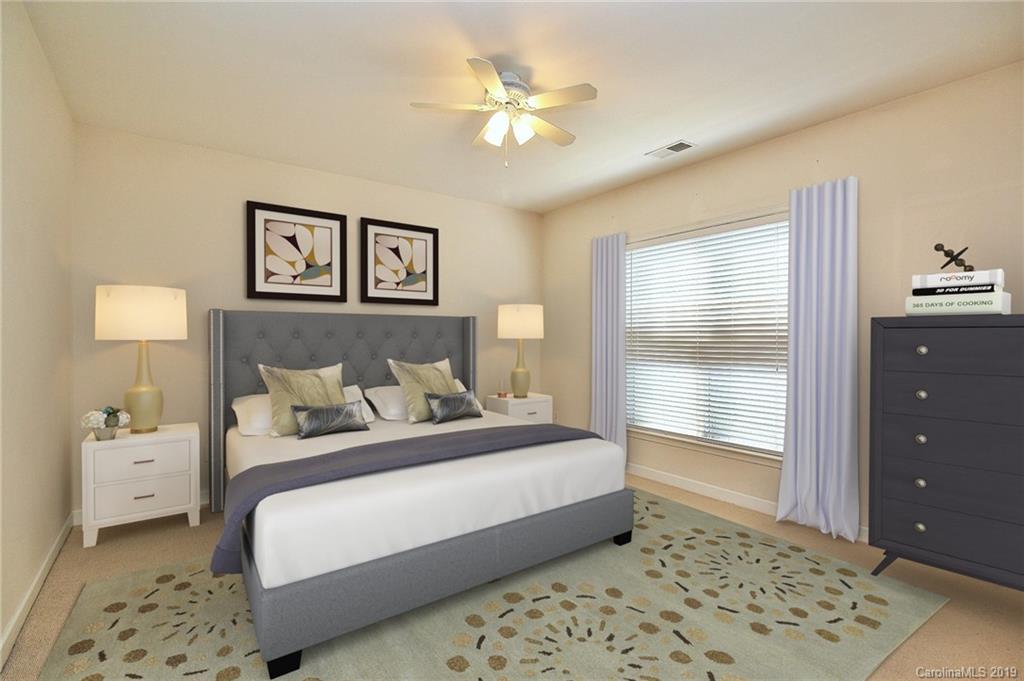4154 Walker Road Charlotte, NC 28211 - Photo 29 of 37 a bedroom with a bed and a lamp on dresser