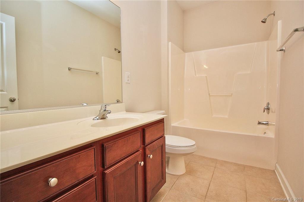 4154 Walker Road Charlotte, NC 28211 - Photo 33 of 37 a bathroom with a sink a toilet a shower and a mirror