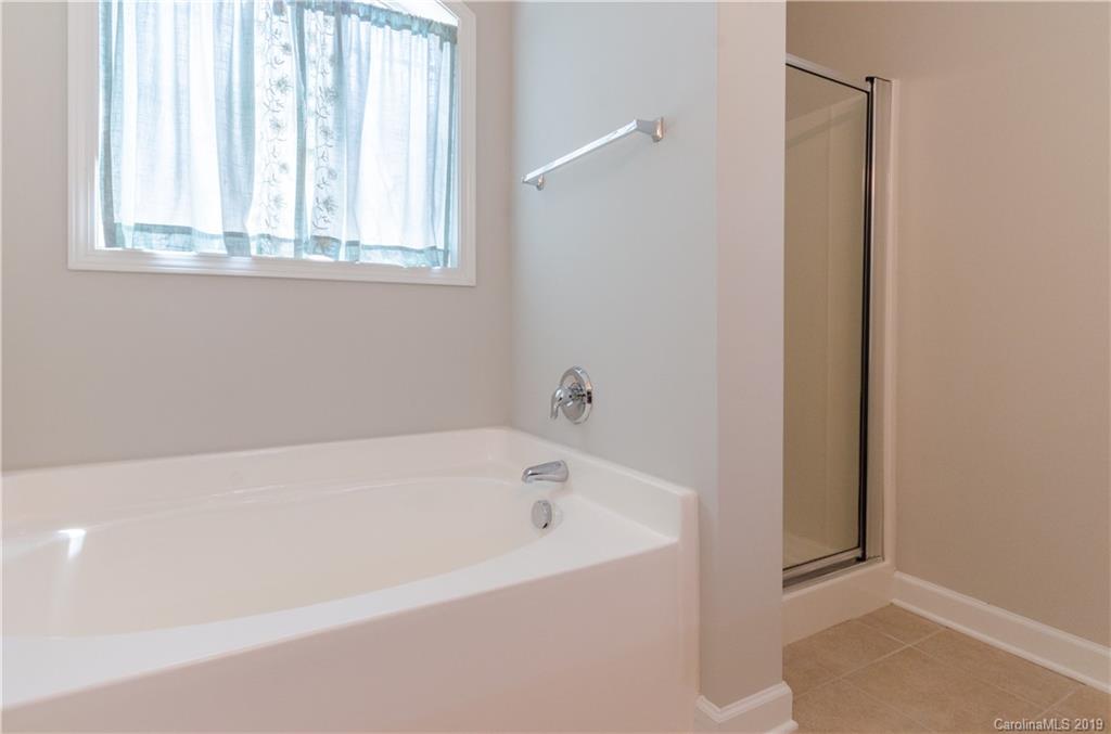 4154 Walker Road Charlotte, NC 28211 - Photo 35 of 37 a white bath tub sitting next to a window