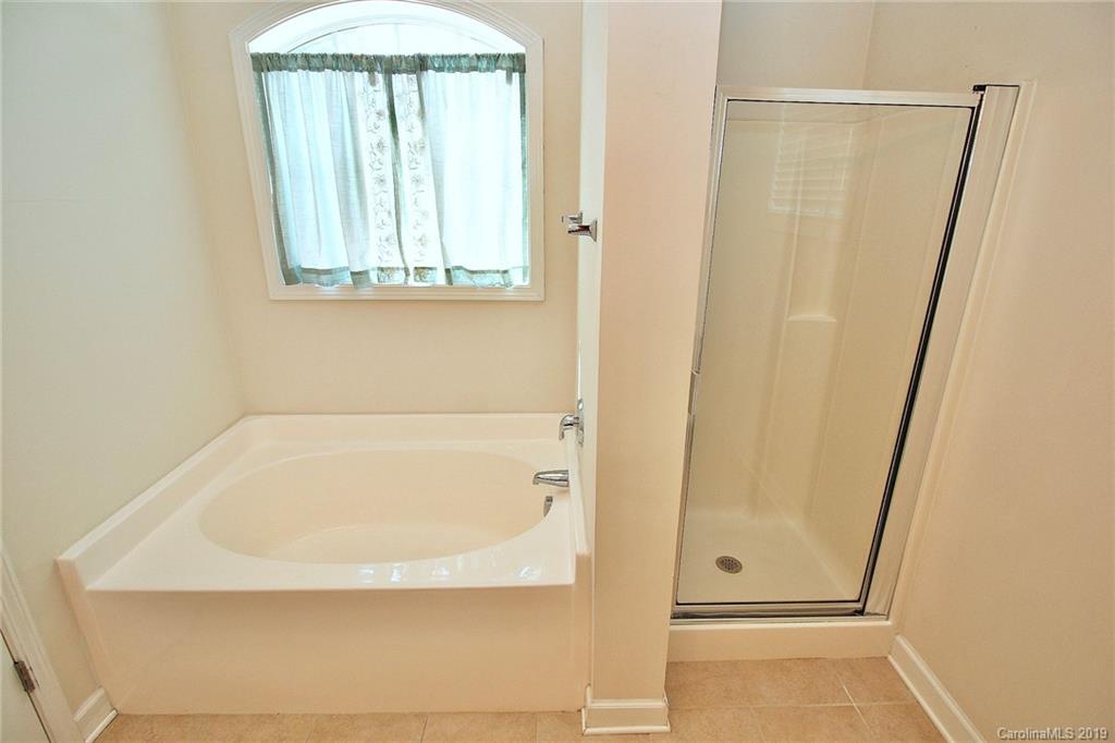 4154 Walker Road Charlotte, NC 28211 - Photo 36 of 37 a bathroom with a bathtub