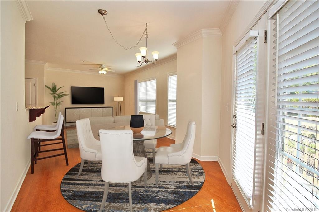 4154 Walker Road Charlotte, NC 28211 - Photo 9 of 37 a view of a dining room with furniture a rug and wooden floor