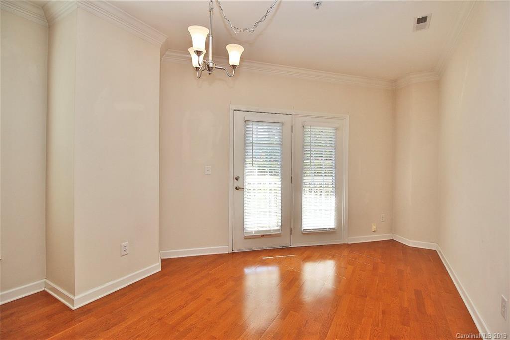 4154 Walker Road Charlotte, NC 28211 - Photo 10 of 37 an empty room with wooden floor cabinet and windows