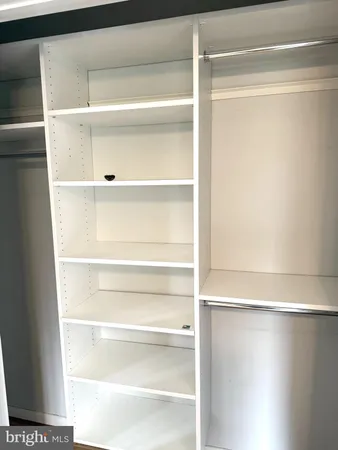 a view of an empty walk in closet
