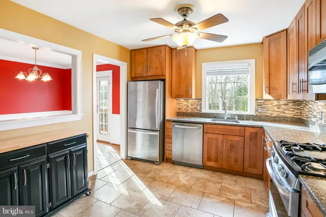 a kitchen with stainless steel appliances granite countertop a stove top oven a sink and dishwasher