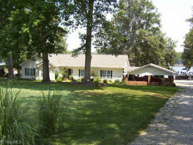Exterior Front. Note boathouse, boat ramp, and dock at end of driveway.