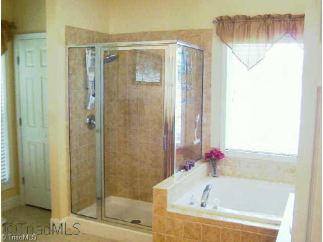 129 Doc Mcculloch Road Lexington, NC 27292 - Photo 8 of 9 Other. Luxury master bath has tile floors, tile shower, and view of lake.