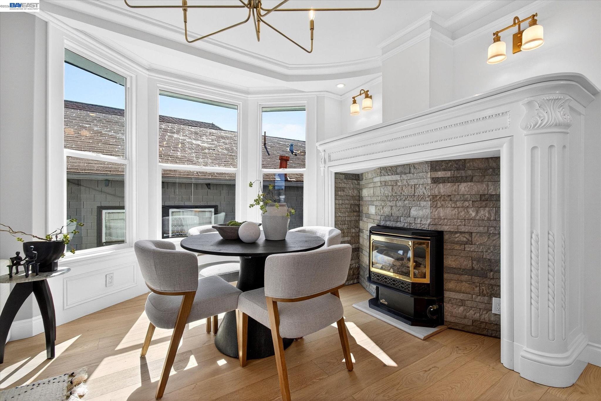 552 Haight Avenue Alameda, CA 94501 - Photo 11 of 43 a dining room with furniture and a fireplace