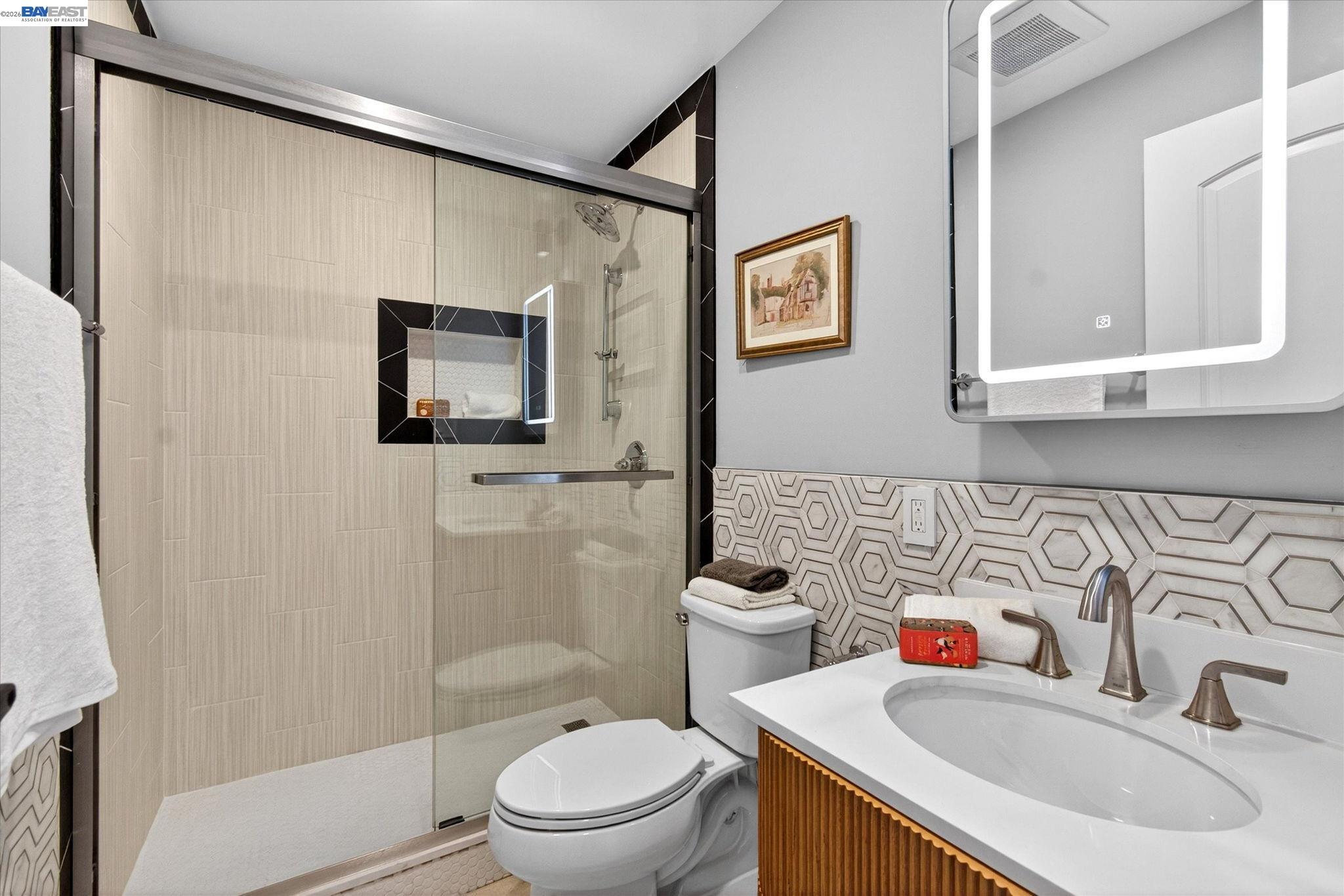 552 Haight Avenue Alameda, CA 94501 - Photo 38 of 43 a bathroom with a toilet sink and mirror