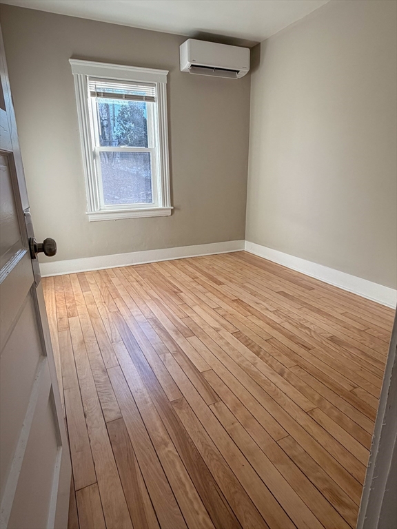 4 Vernon Terrace, Unit 3 Worcester, MA 01610 - Photo 2 of 9 a view of an empty room with wooden floor and a window