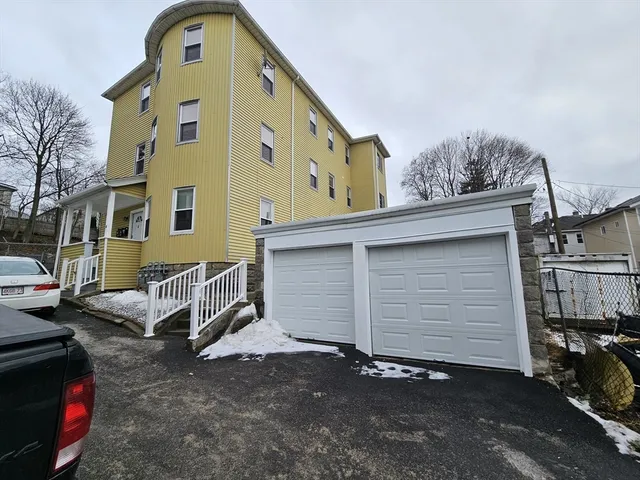 a front view of a house with parking space