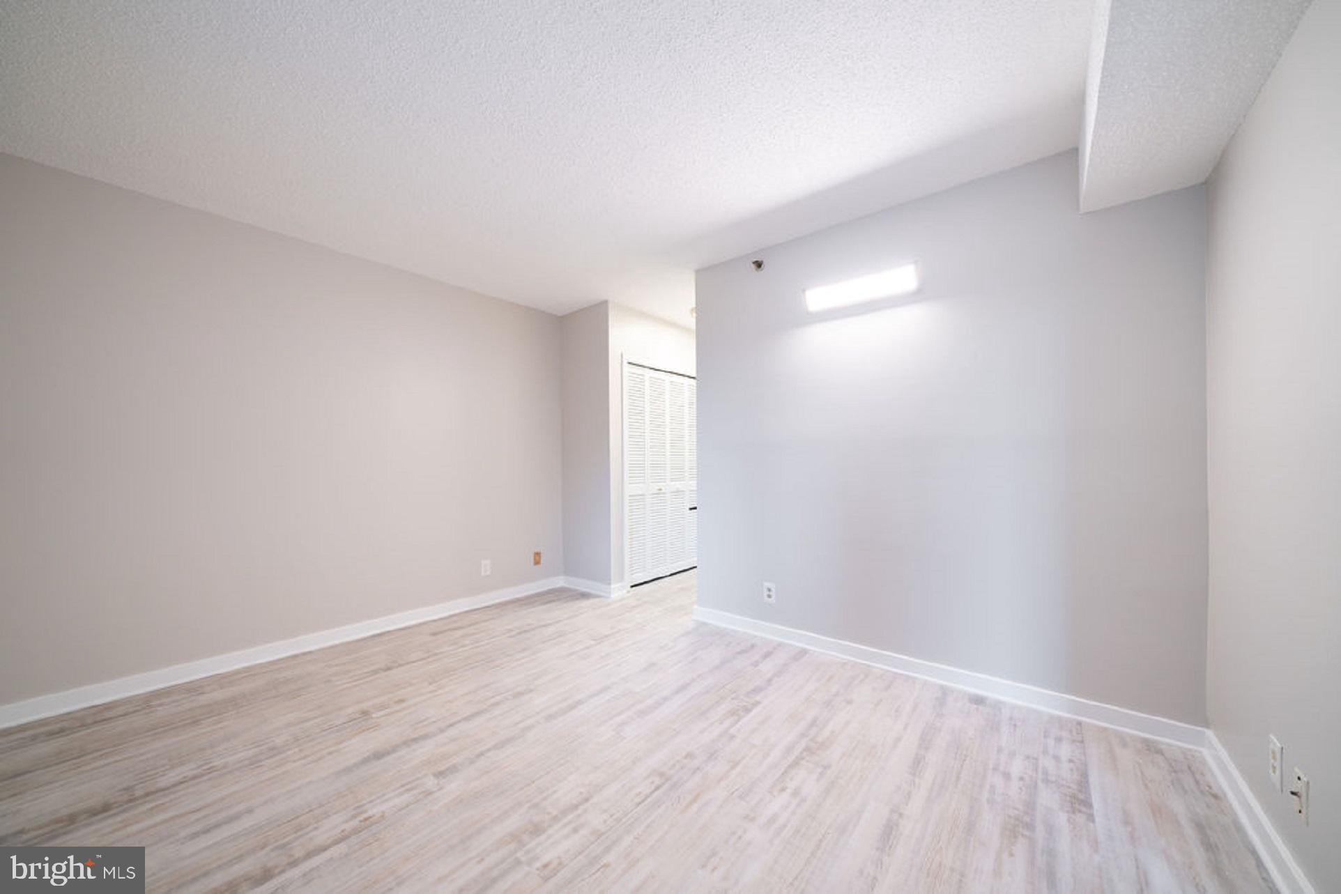 5505 Seminary Road, Unit 103N Falls Church, VA 22041 - Photo 24 of 59 a view of an empty room with wooden floor and a window