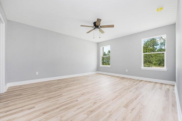 5428 Bayleaf Drive Crestview, FL 32539 - Photo 12 of 23 wooden floor in an empty room with a window